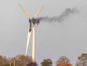 A windmill with smoke coming out of it Description automatically generated with medium confidence